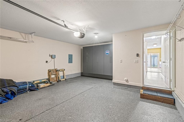 garage with electric panel, baseboards, and a garage door opener