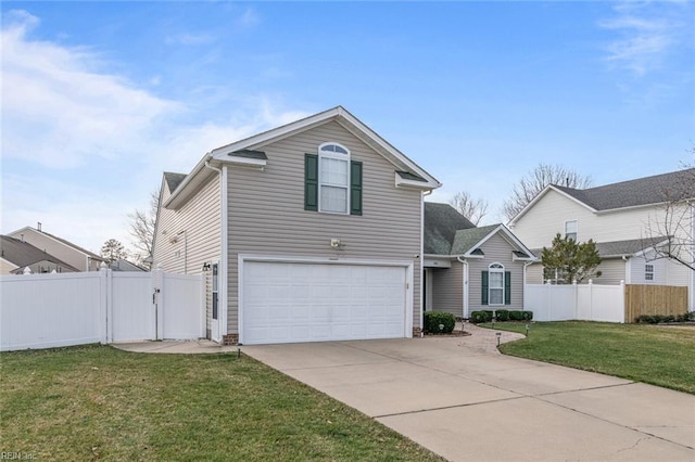 traditional-style home with an attached garage, driveway, a front lawn, and fence