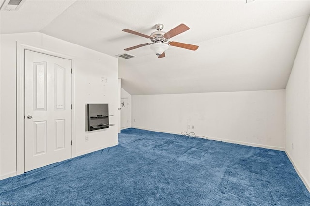 bonus room with lofted ceiling, visible vents, and dark carpet