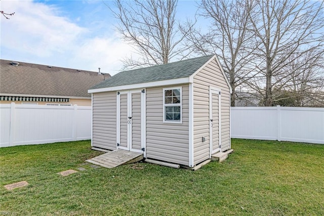 view of shed with a fenced backyard