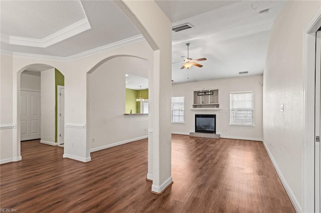 unfurnished living room with ceiling fan, visible vents, dark wood finished floors, and a glass covered fireplace