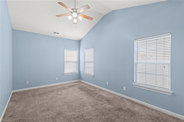 carpeted spare room featuring a ceiling fan, lofted ceiling, visible vents, and baseboards