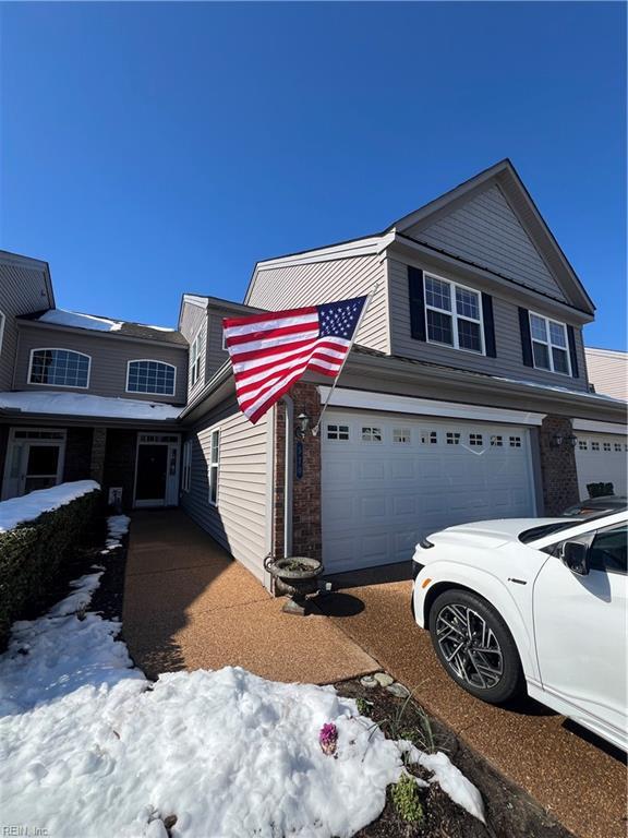 view of snowy exterior with brick siding