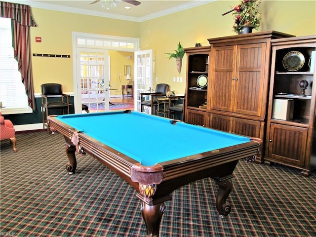 recreation room with ceiling fan, baseboards, french doors, dark colored carpet, and crown molding