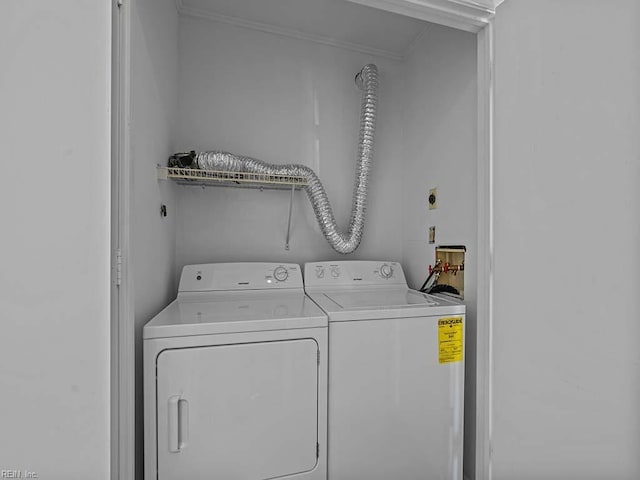 laundry area featuring ornamental molding, laundry area, and independent washer and dryer