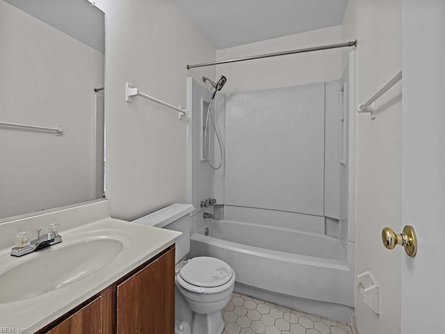 bathroom featuring washtub / shower combination, toilet, vanity, and tile patterned floors