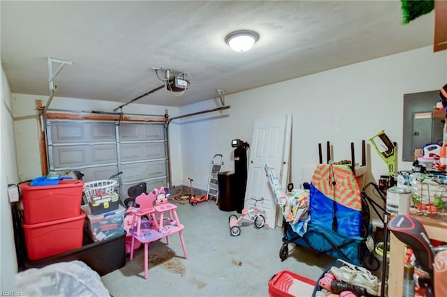 garage with a garage door opener and electric panel