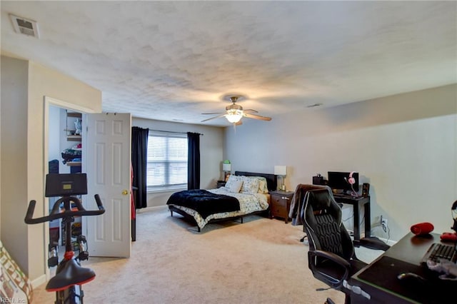 carpeted bedroom featuring visible vents, ceiling fan, and baseboards