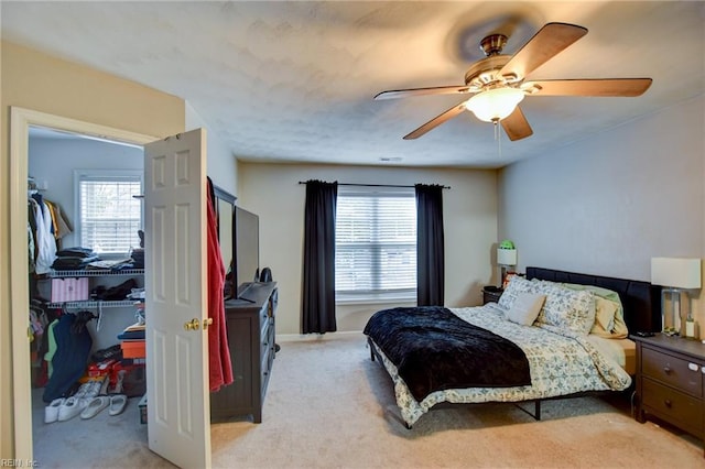 bedroom featuring light colored carpet, multiple windows, and ceiling fan