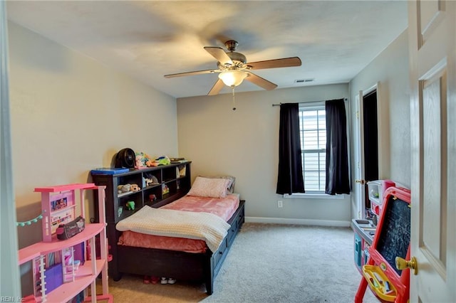 bedroom with light colored carpet, ceiling fan, visible vents, and baseboards