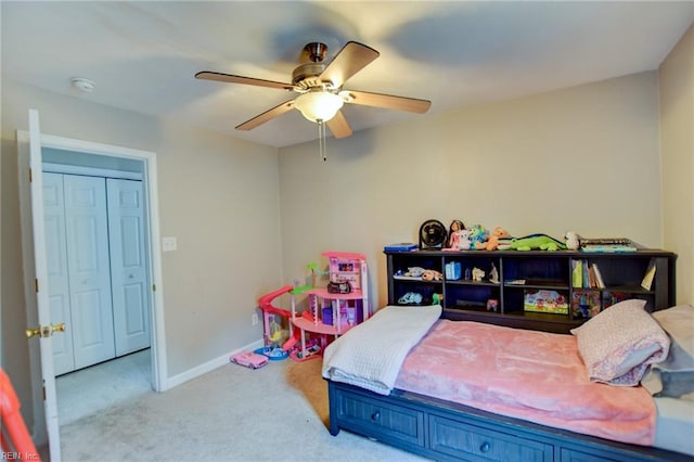 bedroom with a ceiling fan, light carpet, and baseboards