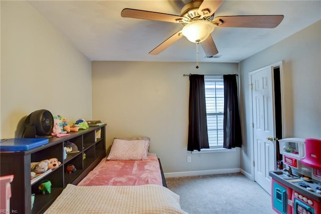 carpeted bedroom with a ceiling fan, visible vents, and baseboards