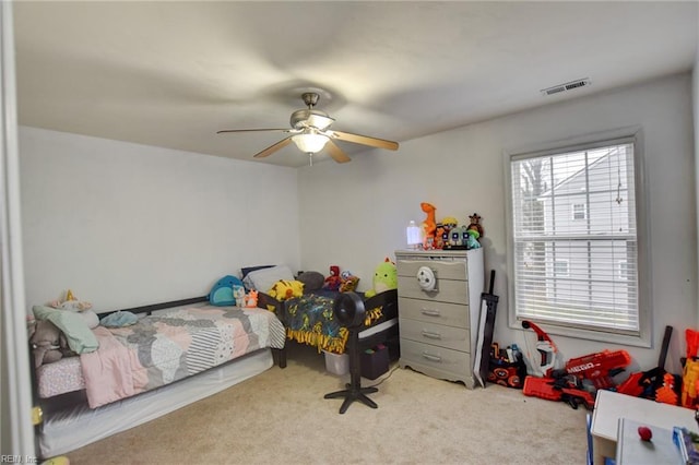 bedroom with visible vents, a ceiling fan, and light colored carpet