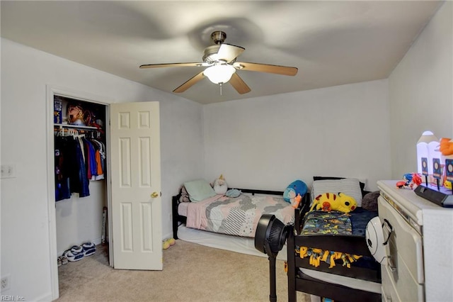 bedroom featuring light carpet, ceiling fan, and a closet