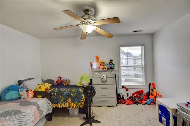 bedroom featuring visible vents, a ceiling fan, and light colored carpet