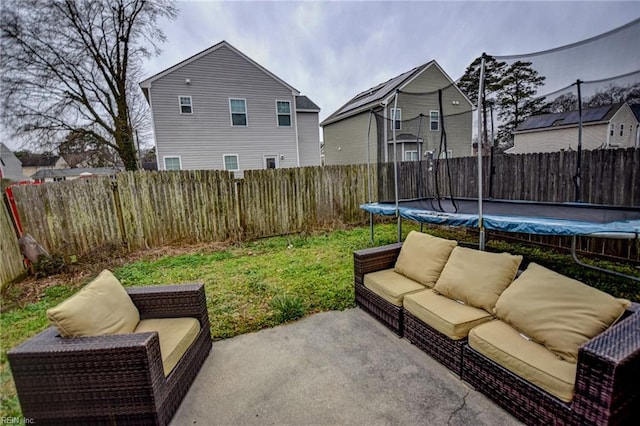 view of patio / terrace featuring a trampoline and a fenced backyard