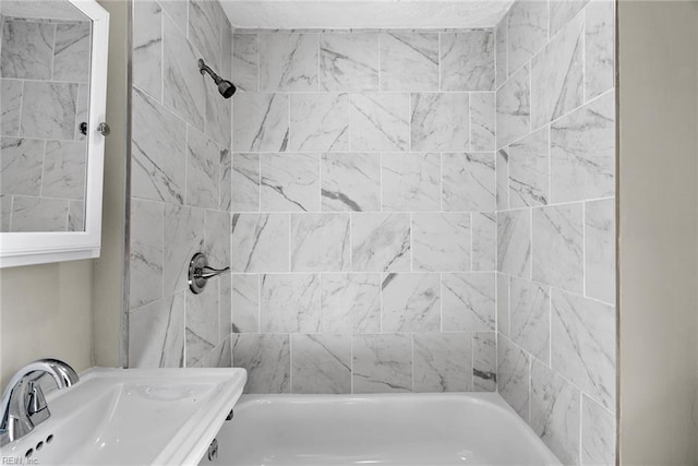 bathroom featuring tub / shower combination and a sink