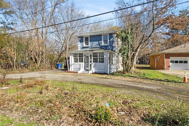 view of front of property with covered porch and dirt driveway