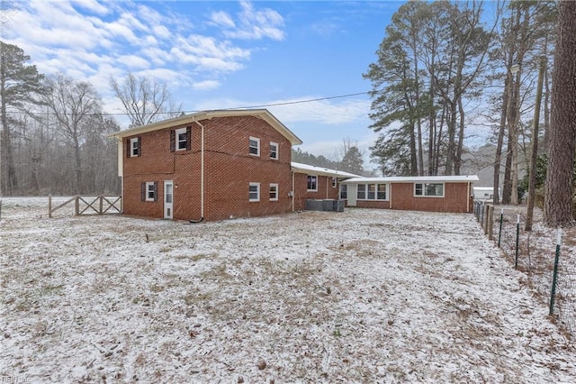 snow covered house with brick siding