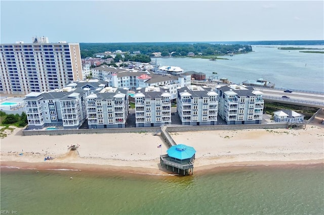 birds eye view of property featuring a beach view and a water view