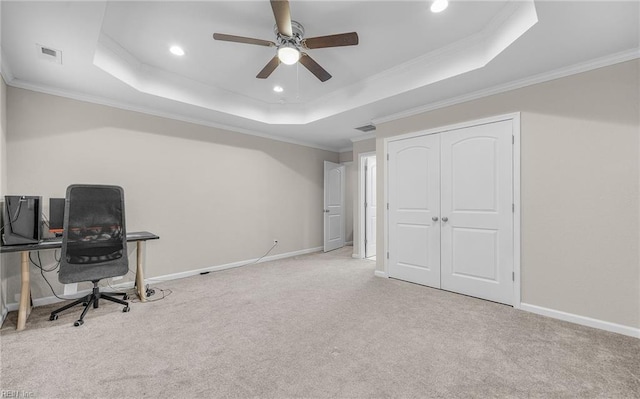 office space with ornamental molding and a tray ceiling