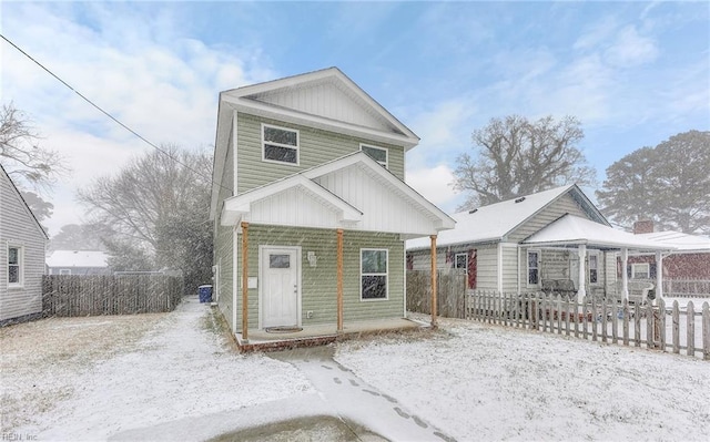 view of front facade with a fenced front yard, a porch, and board and batten siding