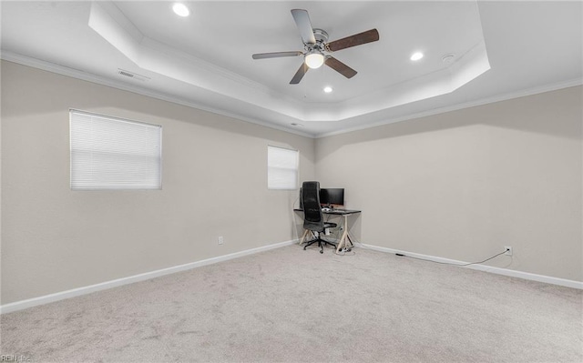 unfurnished office featuring carpet floors, baseboards, and a raised ceiling