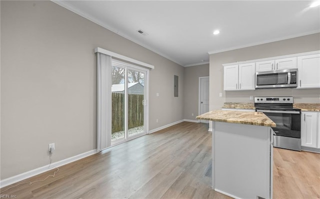 kitchen featuring stainless steel appliances, a center island, light stone countertops, and white cabinets