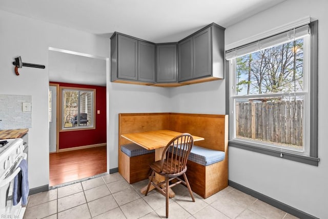 dining area with baseboards and light tile patterned floors