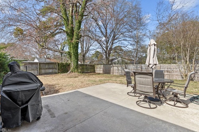 view of patio featuring a fenced backyard, outdoor dining area, and area for grilling