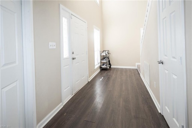 interior space with dark wood-style floors and baseboards