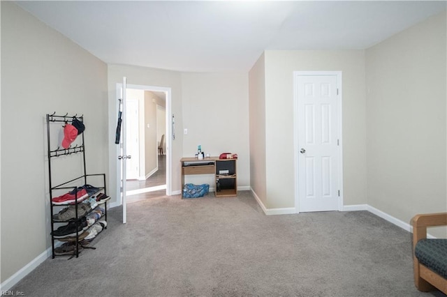 interior space with carpet and baseboards