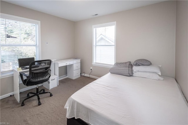 bedroom with carpet, visible vents, and baseboards