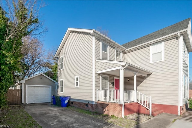 view of front facade with concrete driveway, a detached garage, crawl space, covered porch, and an outdoor structure