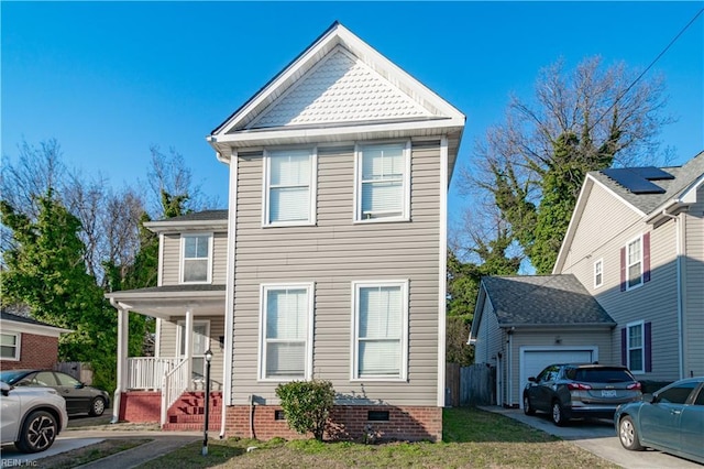 traditional home with covered porch, driveway, crawl space, and an attached garage