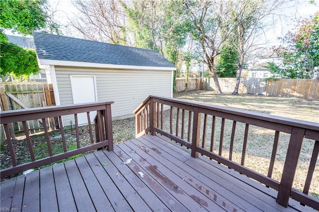 wooden deck with an outbuilding and a fenced backyard