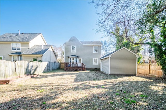 rear view of house featuring a fenced backyard and a deck