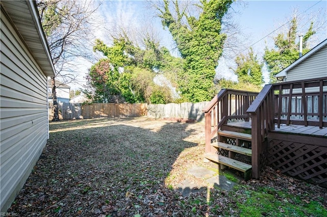 view of yard featuring a fenced backyard and a wooden deck