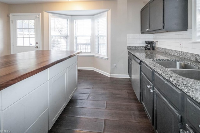 kitchen with dark wood-style floors, a wealth of natural light, and tasteful backsplash