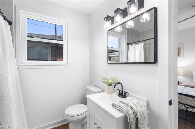 full bath with a shower with shower curtain, vanity, toilet, and baseboards