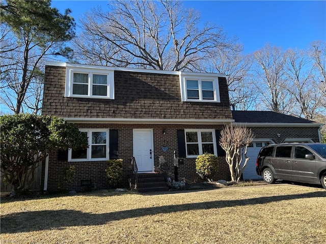 view of front of house featuring entry steps, an attached garage, a shingled roof, brick siding, and driveway