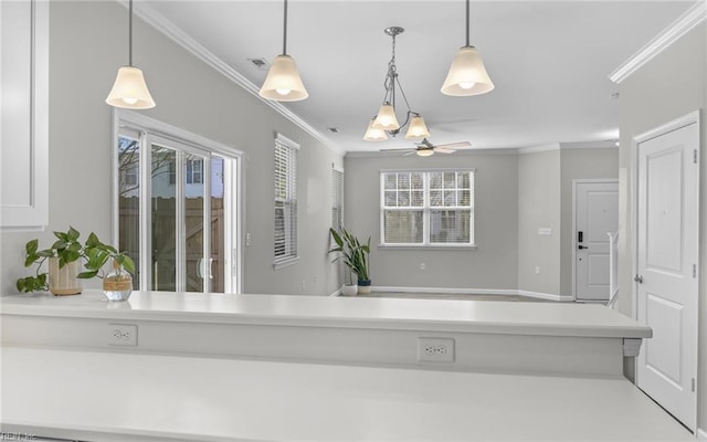 kitchen with hanging light fixtures, light countertops, visible vents, and crown molding