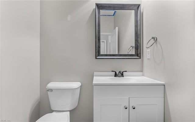 half bathroom with toilet and vanity