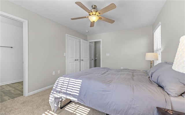 bedroom with ceiling fan, baseboards, and carpet flooring