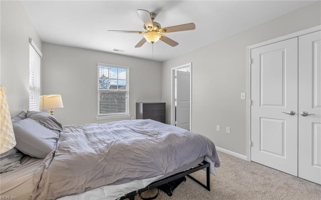 bedroom with carpet floors, visible vents, baseboards, and a ceiling fan