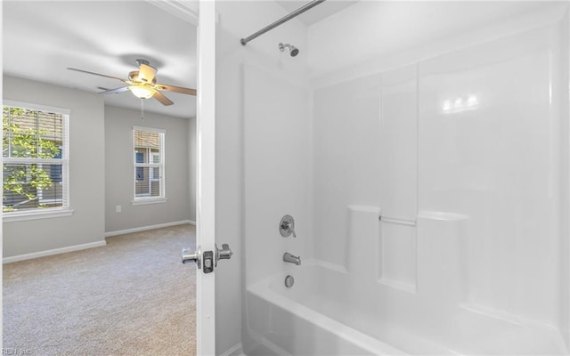 bathroom featuring baseboards, a ceiling fan, and bathing tub / shower combination