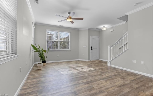 entryway featuring crown molding, stairs, baseboards, and wood finished floors