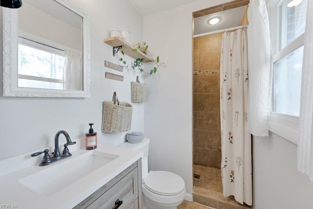 full bathroom featuring vanity, a shower stall, and toilet