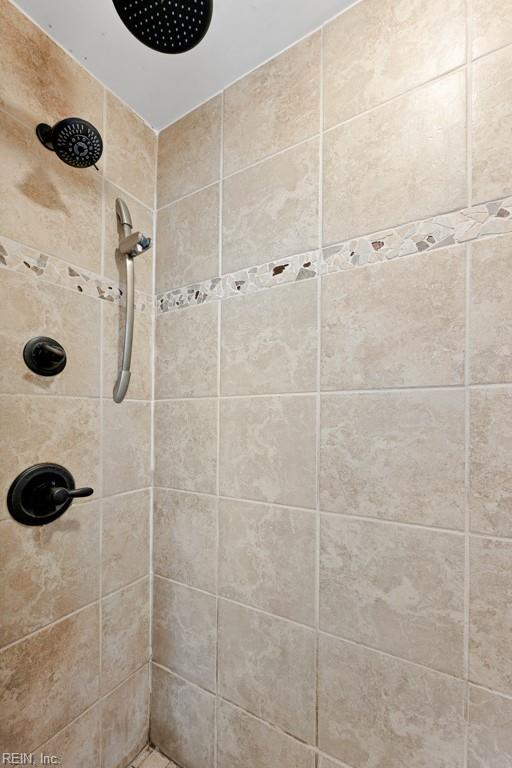 full bath with a tile shower