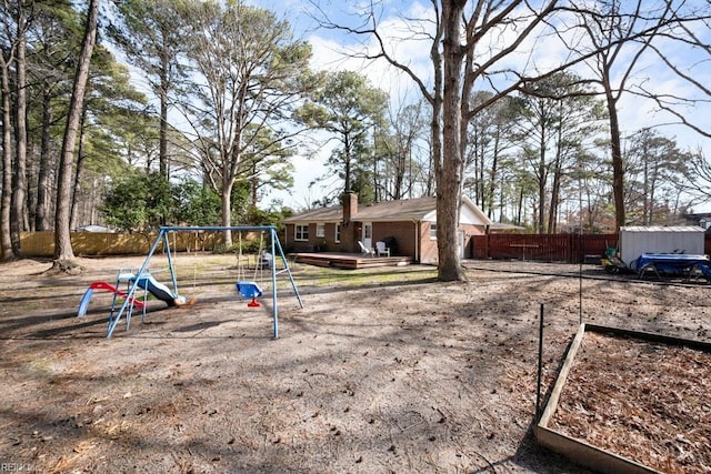 view of yard with fence and playground community